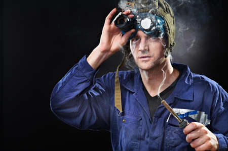 Crazy genius guy wearing weird hat with soldering iron in handの写真素材
