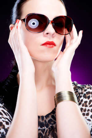 Beautiful elegant young woman with sunglasses, studio shot