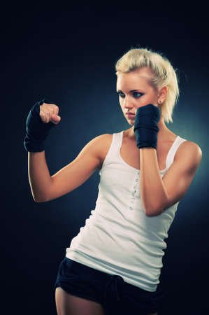 Attractive blonde fighter girl, studio shot, cross processedの写真素材