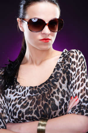 Elegant young woman in sunglasses, studio shotの写真素材