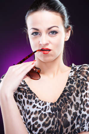 Elegant young woman with sunglasses, studio shotの写真素材