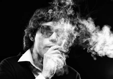 Closeup portrait of a smoking man with cigar
