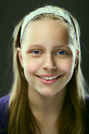 Portrait of a cute smiling teen girl, studio shot