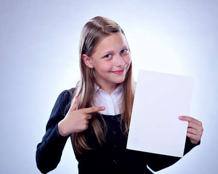 Portrait of a happy teenage girl with a blank board, studio shotの写真素材