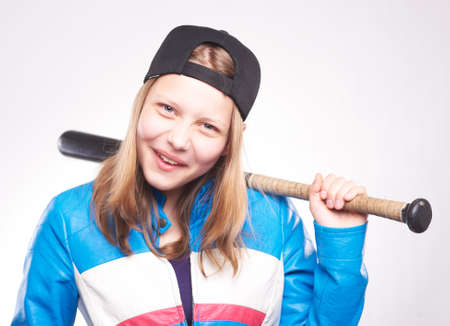 Portrait of a teen girl with bat, studio shotの写真素材