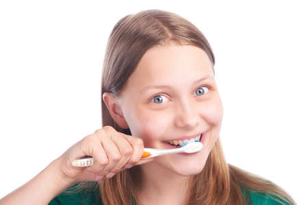 happy teen girl with toothbrush, studio shotの写真素材