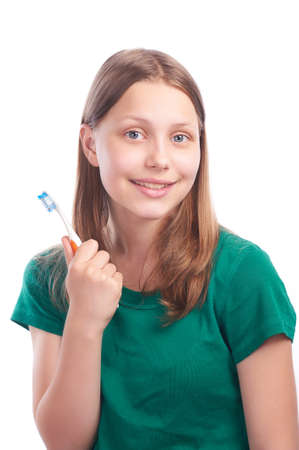 happy teen girl with toothbrush, studio shotの写真素材