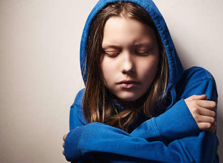 Afraided teen girl, studio shotの写真素材