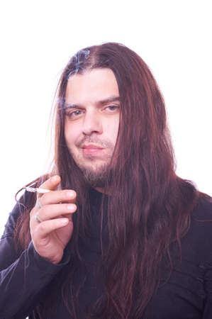 Dude with flowing hair smoking, studio shotの写真素材