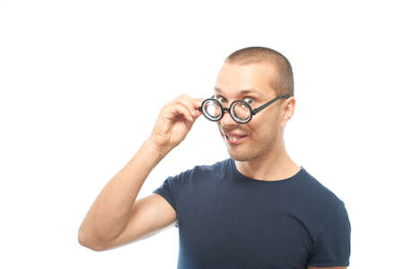 Young nerd with glasses looking at the camera and try to flirting, isolated on whiteの写真素材