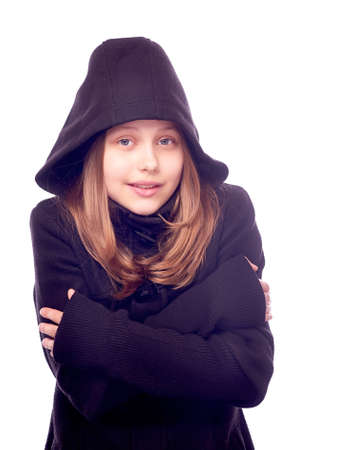 Beatiful teen girl dressed in coat staying and warmedの写真素材