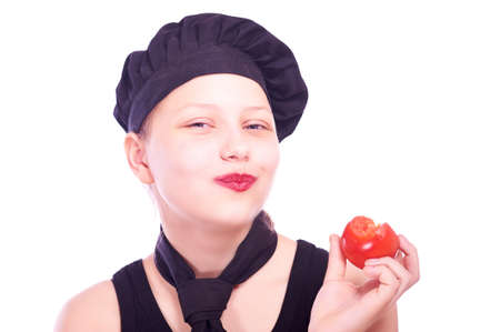 Cute happy teen girl eating tomato and smilingの写真素材