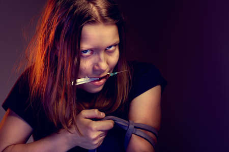 Teen girl addict with syringeの写真素材