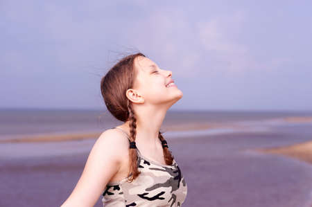 Cute happy teen girl having fun on the beach