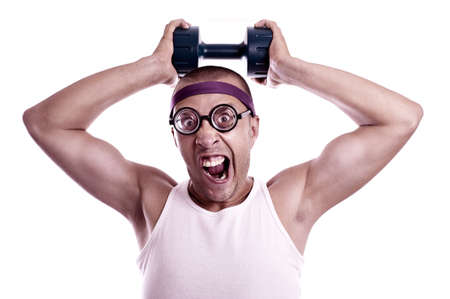 Portrait of a silly nerd in glasses with dumbbell trainsの写真素材