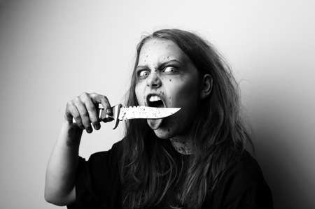 Girl possessed by a devil cuts tongueの写真素材
