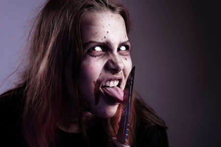 Girl possessed by a devil cuts tongueの写真素材