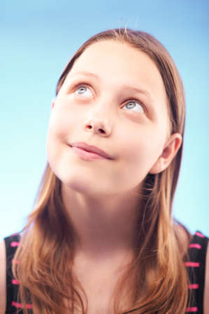 Cute teen girl looking up and smiling