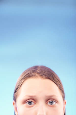 Sad teen girl with despair in her eyes. Half of the face