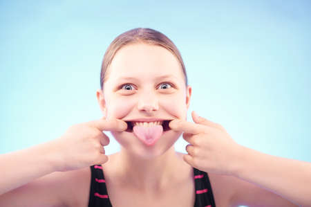 Funny silly teen girl grimacingの写真素材