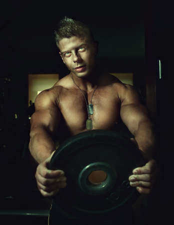 Portrait of a strong handsome guy posing. Bodybuilderの写真素材