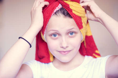 Beautiful happy teen girl with towel on her head smilingの写真素材