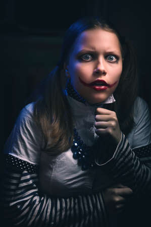 Portrait of an afraid clown teen girl