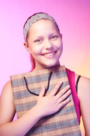 Beautiful happy teen girl receives a gift on a birthdayの写真素材
