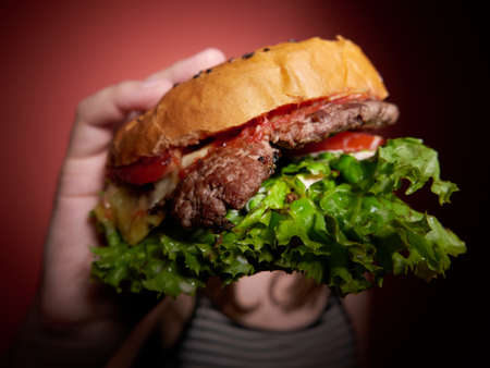 Teen girl with a delicious burgerの写真素材