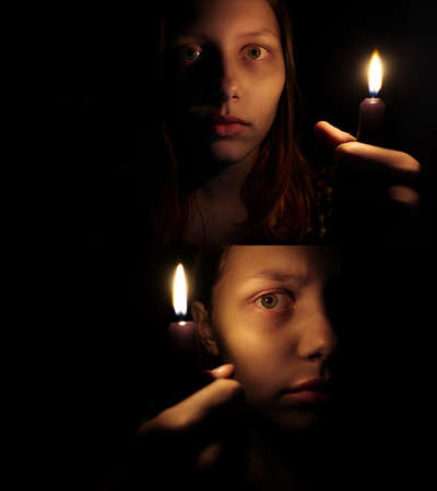 Teen girl with a candle, fear on her faceの写真素材