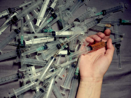 Drug addict. Photo a of human hand with syringe.の写真素材