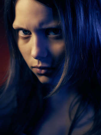 Portrait of a psycho teen girl, studio shot.の写真素材