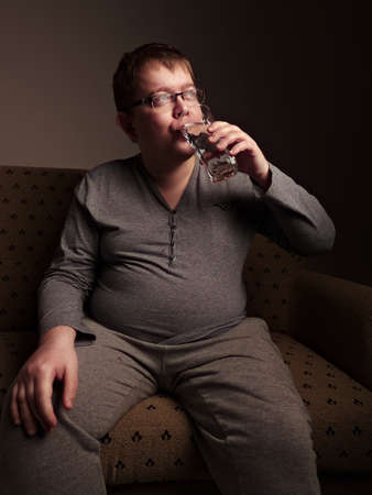 Overweight man drinking waterの写真素材