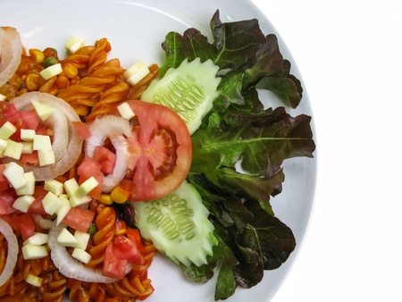 Organic vegetarian salad topped with olive oil dressing on white plate isolatedの写真素材