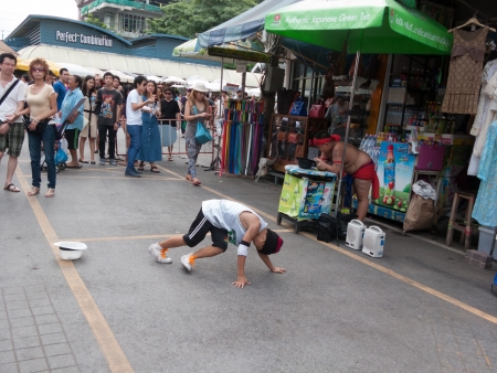 Bangkok, Thailand - August 11 : Unidentified boy is performing steet dance show on August 11, 2012 at Jatujak weekend market, Bangkok, Thailand.のeditorial素材