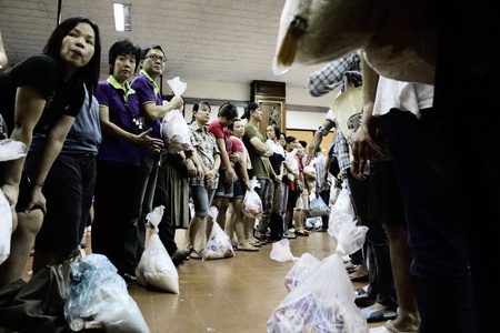 BANGKOK, THAILAND - OCTOBER 16 : Unidentified volunteers form themselves into human conveyor belt to...