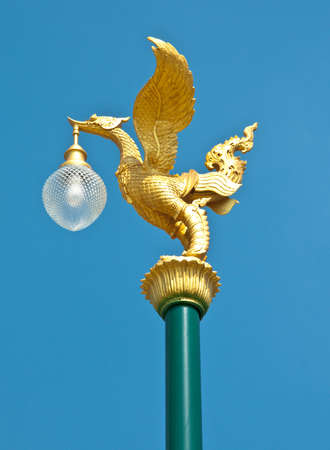 thai style light pillar lantern with blue skyの写真素材