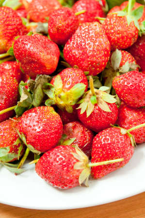 strawberry in white dish with table backgroundの写真素材