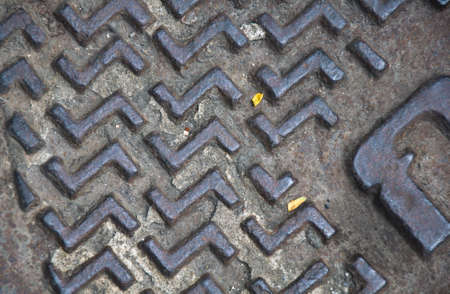 Photo of an iron in sidewalkの写真素材