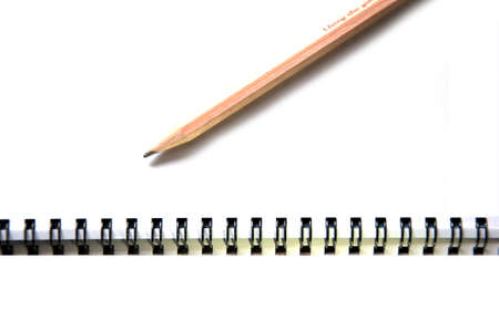 Photograph of a spiral notebook and pencil