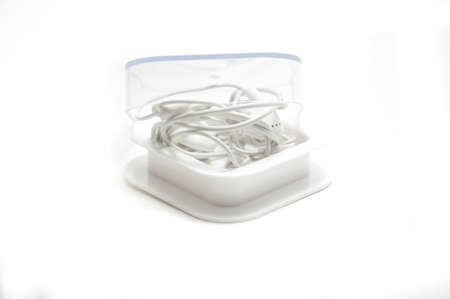 Earphones in box on white backgroundの写真素材