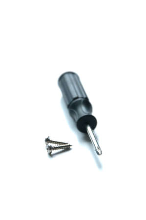 Isolated screwdriver with some screws.の写真素材