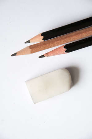three  pencil and one eraser on white backgroundの写真素材