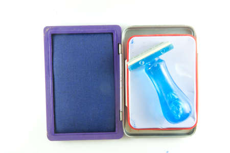 Isolated classic rubber stamp with opened blue ink padの写真素材
