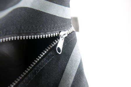 Zipper unzipped on black bagの写真素材