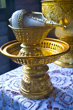Conch shell on golden tray for blessed water in Thai wedding ceremonyの写真素材