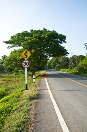 Curvy road sign in Countryside road of Thailandの写真素材