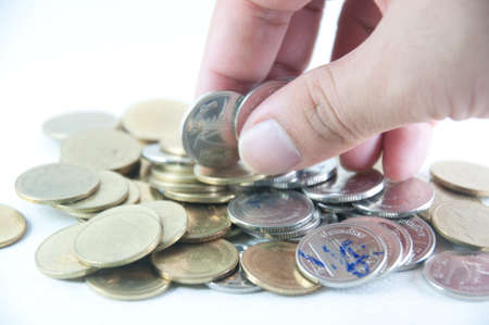 Money savings (a hand putting new money in the stack)の写真素材