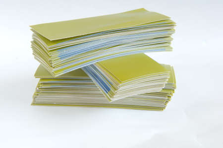 Pile of green paper, isolated on white backgroundの写真素材