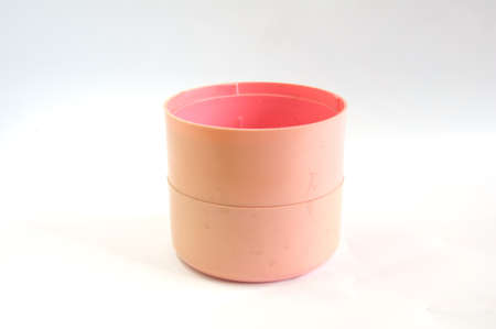 open pink  plastic round box isolated on whiteの写真素材